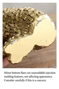 Detailed macro view showing the golden texture and base of a modern abstract sculpture