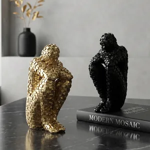 Modern abstract character sculpture in gold and black mosaic style for home decor