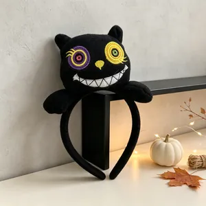 Close-up view of a Halloween plush headband featuring a stylized black cat design