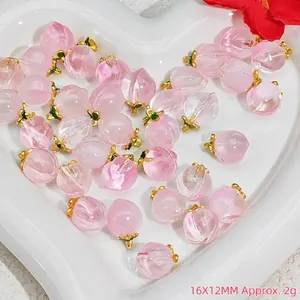 Macro view of pink peach crystal pendants with gold caps for DIY jewelry making