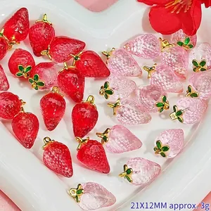Detailed view of red and pink strawberry crystal pendants for DIY jewelry making