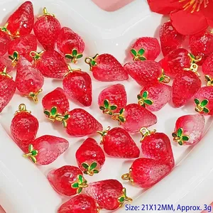 Macro view of translucent red crystal strawberry charms for DIY jewelry making crafts