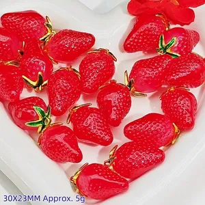 Detailed macro view of red strawberry crystal pendants with gold trim for DIY jewelry