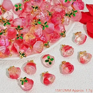 Detailed macro shot of pink crystal peach charms with green leaves for DIY jewelry crafting
