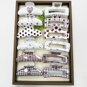 Detailed view of assorted Korean hair claw clips featuring polka dot and heart patterns.