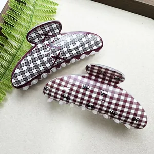 Macro view of Korean style hair claw clips featuring trendy grid and bow patterns