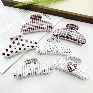Stylish collection of trendy hair claw clips featuring polka dots, grids, and heart patterns.