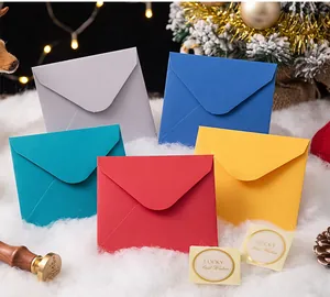 Colorful Christmas mini envelope set with gold stickers in a festive holiday setting
