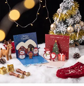 Detail view of 3D pop-up Christmas cards featuring festive Santa and reindeer designs