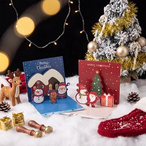 Handmade 3D pop-up Christmas greeting cards with Santa and snowman in a festive snow scene
