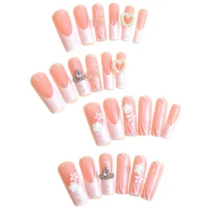 Extra long French tip press-on nails in pink with 3D flower and heart charms