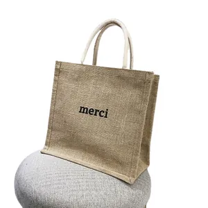 Borsa tote grande in juta ecologica dotata di stampa merci nera e manici robusti
