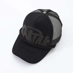 Detail of black American street style trucker hat with mesh and printed letters