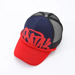Detail view of navy and red trucker hat with graffiti print and rope detail