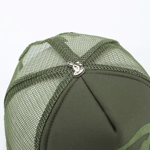 Detail shot of olive green trucker hat with breathable mesh and metal top button.