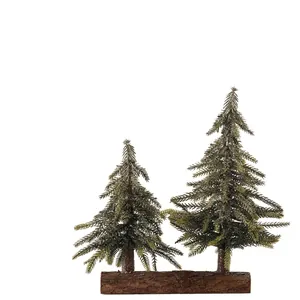 Pair of artificial mini Christmas trees on a rustic wooden base for home desk decoration