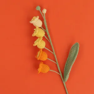 Detailed view of hand-crocheted Lily of the Valley flower with orange gradient