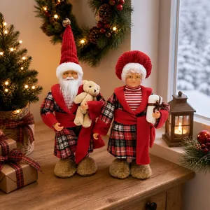 Standing Santa Claus and Mrs. Claus figurines in festive plaid robes for holiday decor