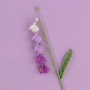 Beautiful handmade crocheted lily of the valley flower with purple gradient yarn texture detail