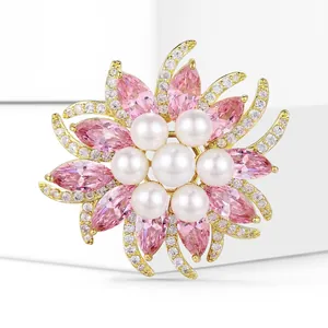 Macro detail of luxury sunflower brooch featuring pink zircons and white pearls
