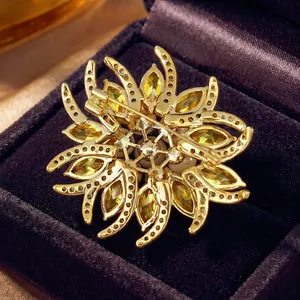 Detailed back view of an elegant gold sunflower brooch with yellow zircons and white pearls