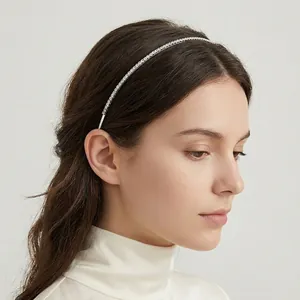 Detailed view of a model wearing a thin minimalist single-row rhinestone headband