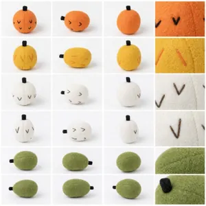 Vue macro détaillée de citrouilles en feutre de lana faites à la main en tons d'automne