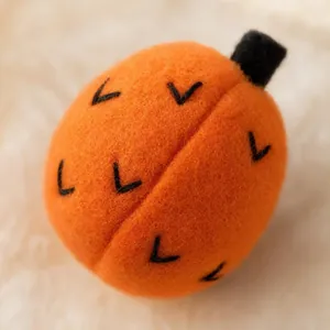 Détail d'une citrouille artisanale en feutre de laine orange pour décoration d'automne