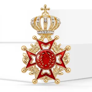 High-quality detailed shot of an elegant gold crown brooch with red enamel and crystals