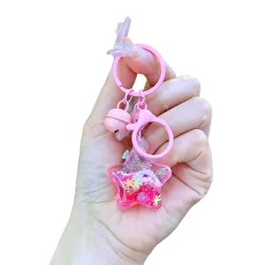 Cute pink star-shaped liquid glitter keychain with decorative bell and lobster clasp