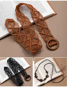 Detail view of bohemian handmade woven belts with vintage wooden rings on open books.
