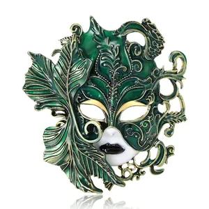Elegant green enamel Venetian mask brooch with intricate gold leaf details for festivals