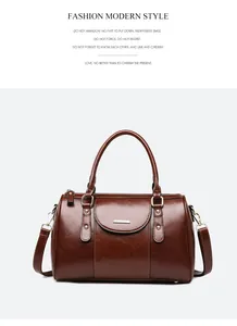 Retro brown oil skin Boston handbag for women featuring top handles and shoulder strap
