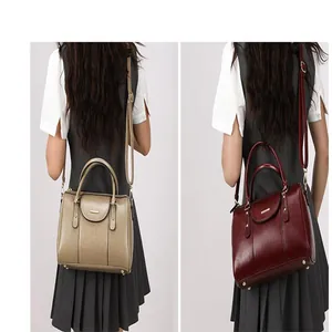Retro oil leather Boston pillow bags in khaki and burgundy shown on model back view