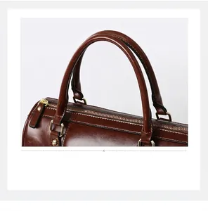 Close-up detail of vintage brown oiled leather Boston bag with sturdy handles