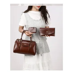 Detailed view of three-piece retro brown oil leather Boston handbag set with matching wallets