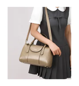 Classic vintage oil leather Boston pillow handbag with adjustable strap shown on model