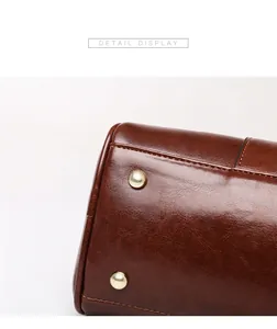Close-up view showing the textured brown oil leather handbag bottom with gold metal studs