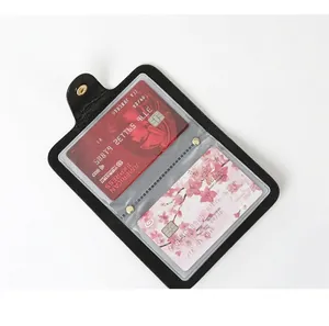 Close-up detail of internal transparent slots in a vintage black leather cardholder with cards