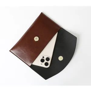 Detail view of retro oil skin pouch showing smartphone fit with magnetic clasp