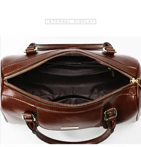 Detailed interior view of vintage brown leather Boston handbag with zipper pockets