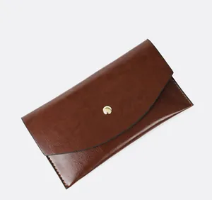 Vintage brown oil-skin leather wallet with minimalist gold snap button closure