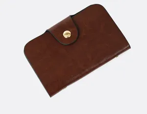 Close-up of vintage brown oil leather clutch purse with a gold snap button closure