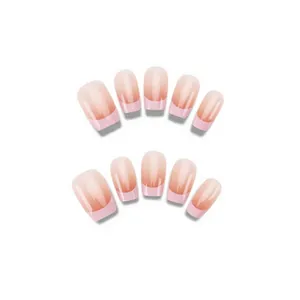 Close-up of pink blush gradient French tip short ballet press-on nails in sets