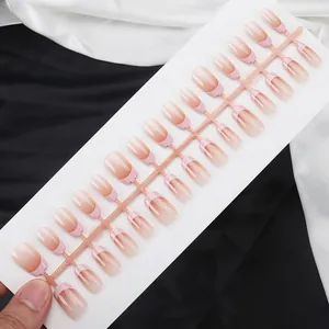 Detailed macro view of short ballet press-on nails with pink blush French gradient