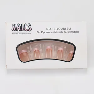 Detailed view of French ombre press-on nails with pink blush gradient in a box