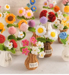 Collection of colorful hand-crocheted potted flower ornaments in mini knitted vases