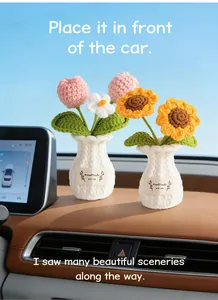 Handmade crochet tulip and sunflower potted plant ornaments placed on a car dashboard.