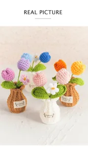 Detailed view of colorful handmade crochet tulip potted flowers on a plain background