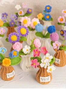 Detailed macro view of handmade crochet flowers in various colors and knitted vases